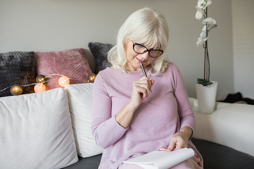 senior lady in glasses holding