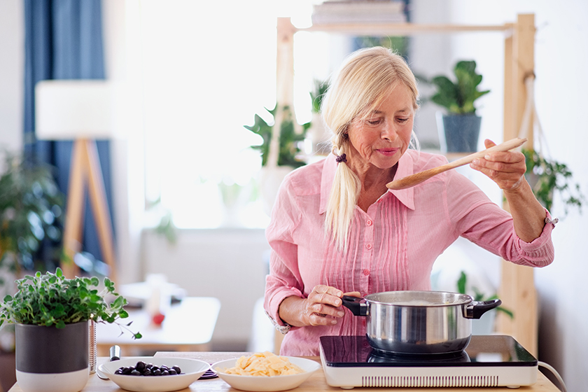 senior woman cooking in kitchen senior woman cooking in kitchen