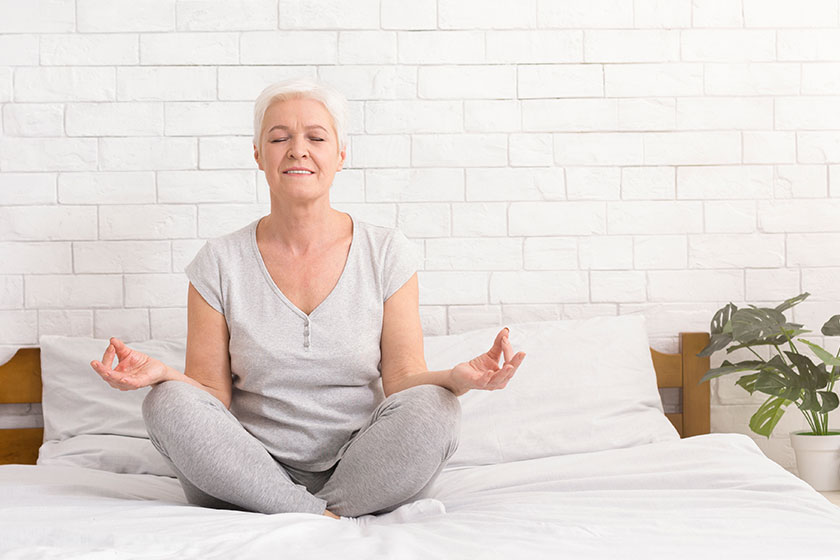 senior woman meditating in lotus