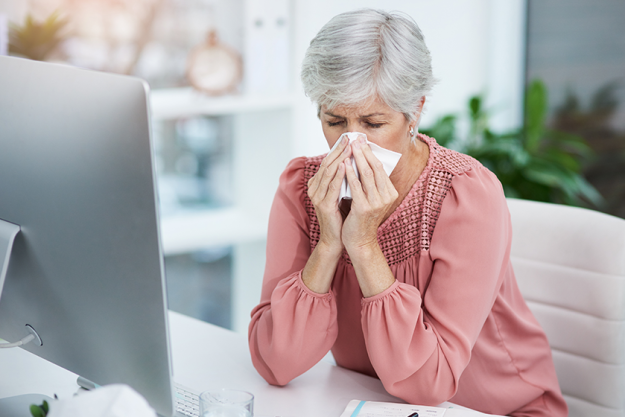 sick days office worst mature businesswoman blowing her nose