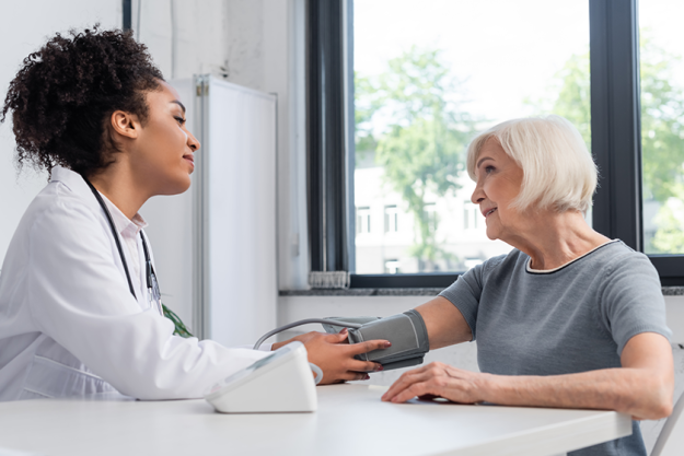 side view african american doctor looking smiling patient