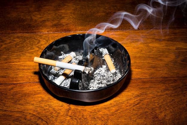 smoking cigarette in ashtray smoking cigarette in ashtray
