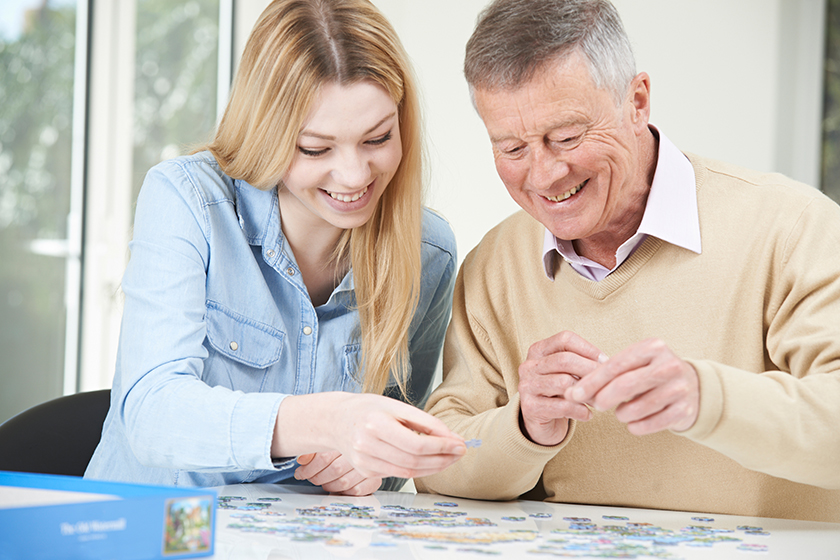 teenage granddaughter helping grandfather