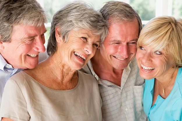 two couples indoors smiling