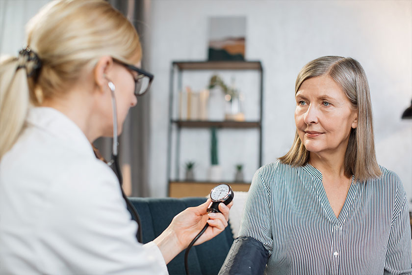 close up photo of blood pressure measurement blurred view of female nurse