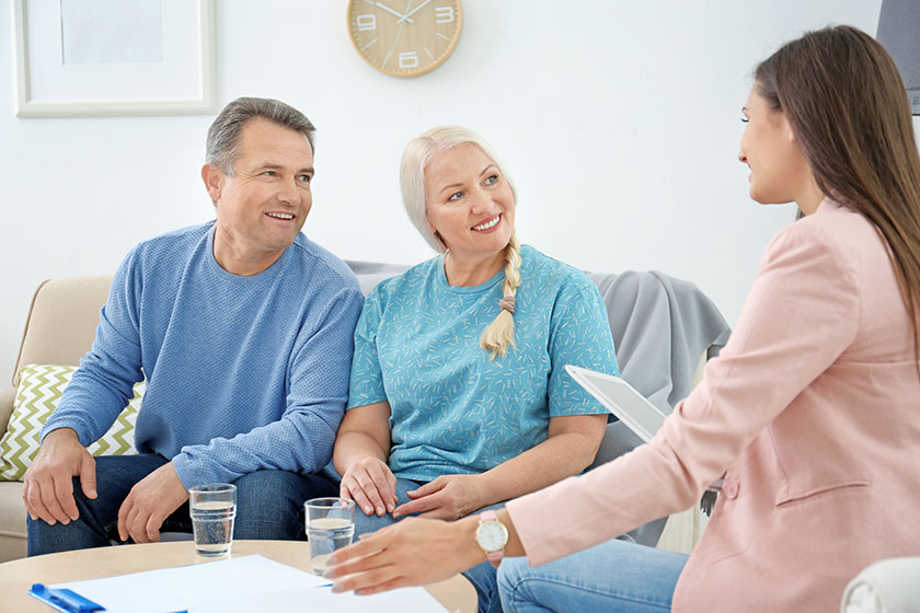 female insurance agent consulting senior couple in office