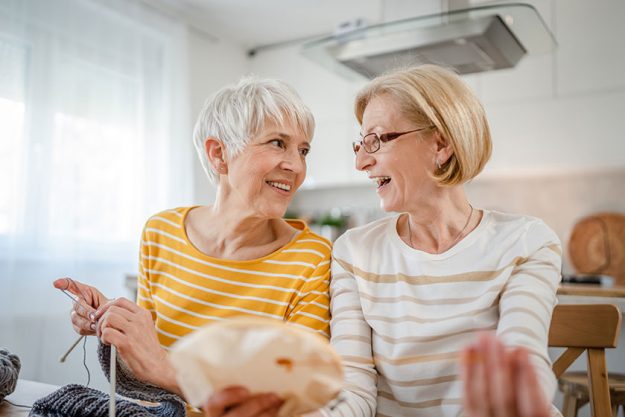 two women senior mature caucasian friends mother daughter sisters knitting two women senior mature caucasian friends mother daughter sisters knitting