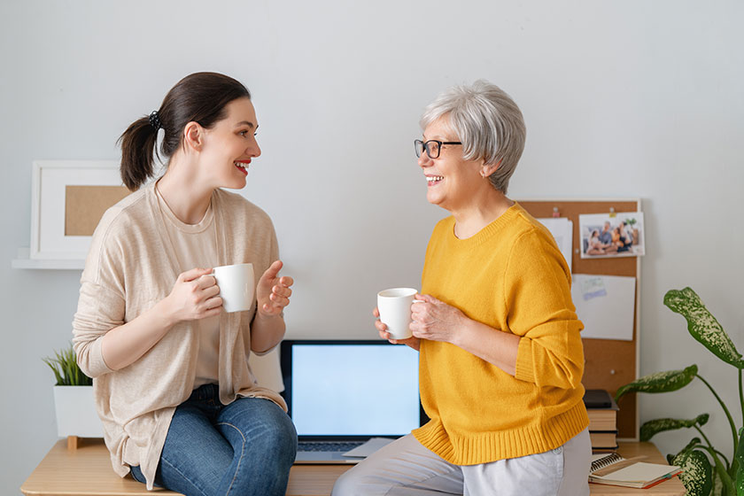 young senior women chatting laughing office