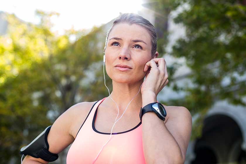 athlete putting her headphones