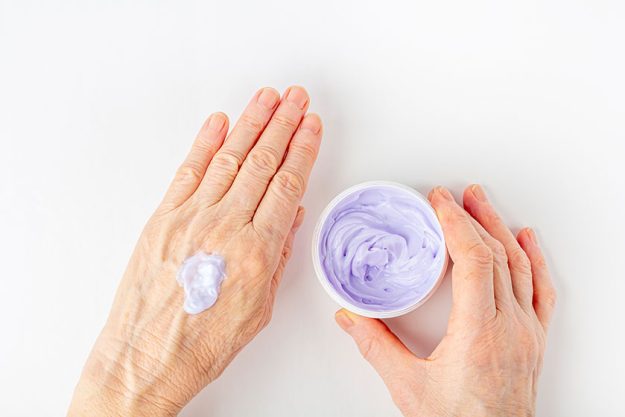 elderly woman creaming her hands close cosmetic moisturizing care old elderly woman creaming her hands close cosmetic moisturizing care old