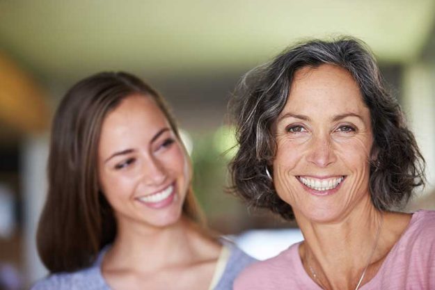 got mama daughter smiling she watches her mom look camera got mama daughter smiling she watches her mom look camera