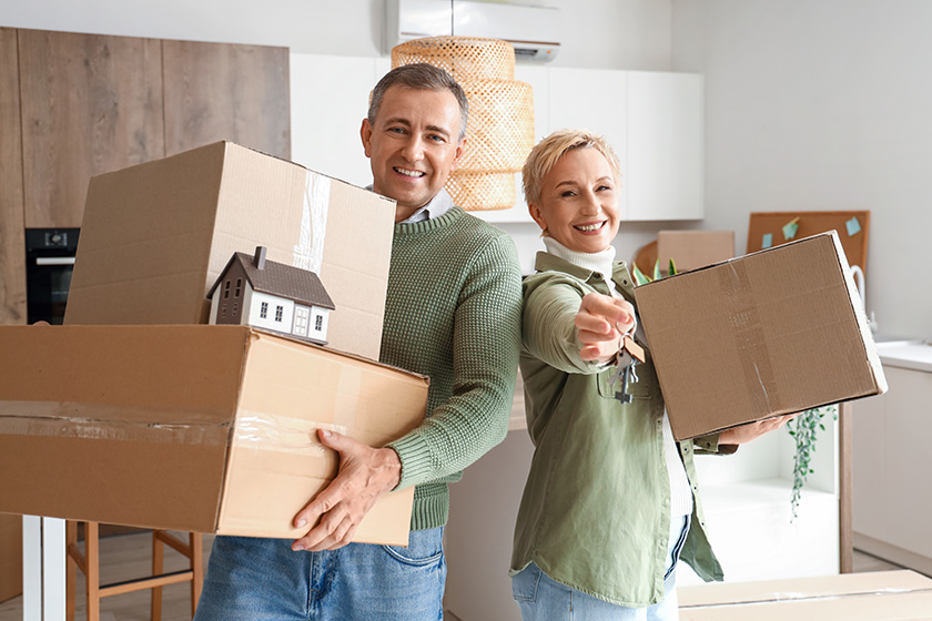 mature couple cardboard boxes keys new flat kitchen moving day mature couple cardboard boxes keys new flat kitchen moving day
