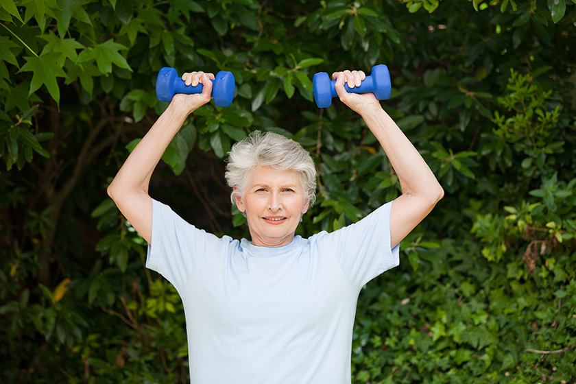mature woman doing her exercises in the garden