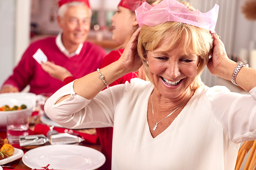 multi generation family santa hats enjoying eating christmas meal home