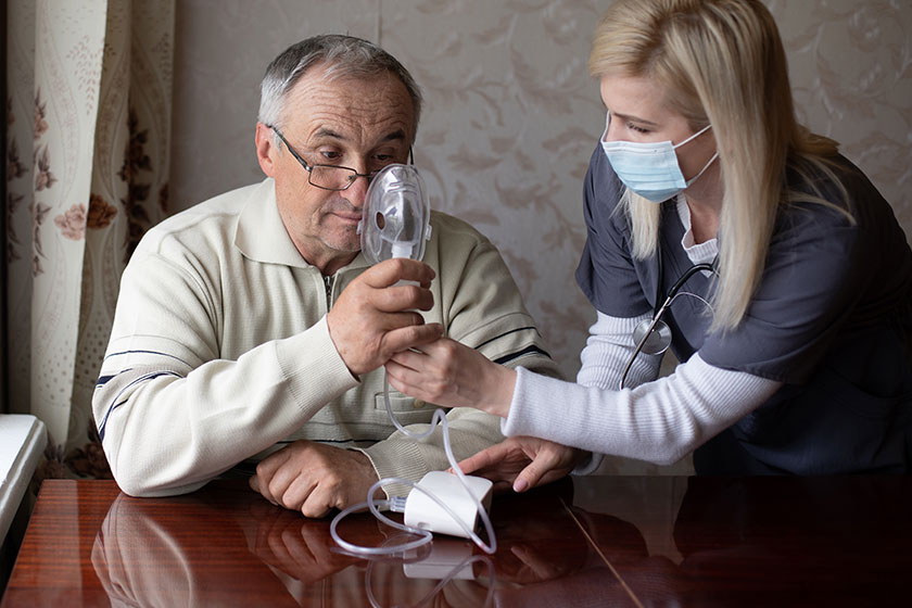 portrait of elderly man with flu inhalation at home the senior caucasian man does inhalation