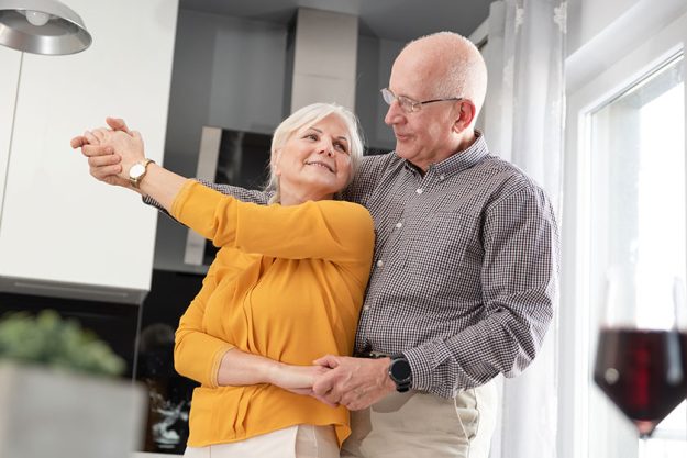 senior couple dancing and smiling at home senior couple dancing and smiling at home