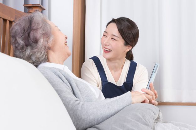asian caregiver old woman nursing home hospital using smartphone asian caregiver old woman nursing home hospital using smartphone