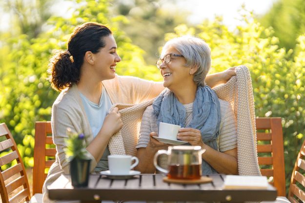 happy young woman her mother drinking tea summer morning family