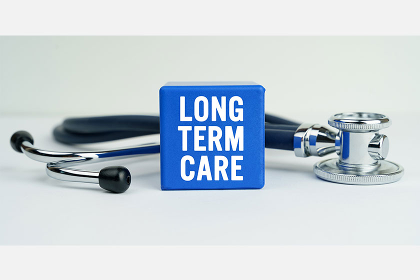 medicine health concept table stethoscope blue cube inscription long term