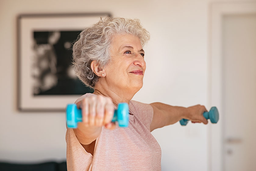senior woman lifting weights working out home old woman doing senior woman lifting weights working out home old woman doing