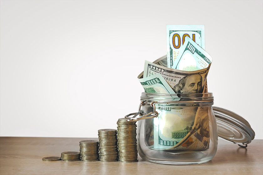 coins stack and us dollar bills in the glass jar coins stack and us dollar bills in the glass jar