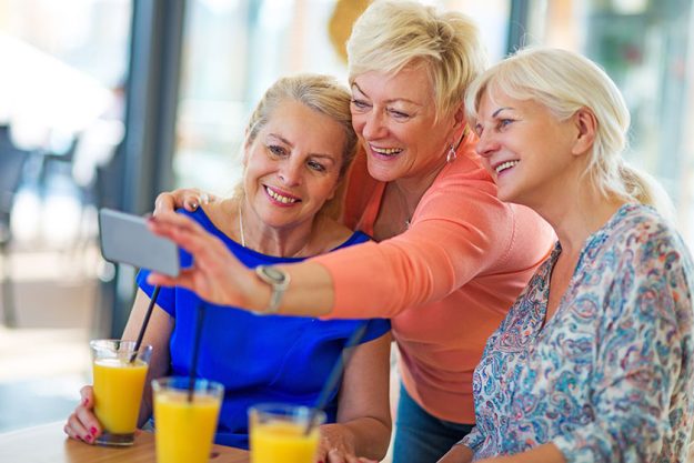 group of senior friends taking a selfie