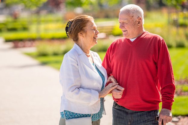happy senior couple summer park