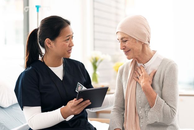 nurse and woman with cancer patient