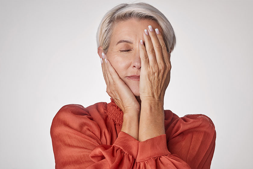 one mature woman suffering headache looking stressed