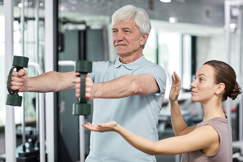 portrait smiling senior man doing exercises gym rehabilitation clinic female portrait smiling senior man doing exercises gym rehabilitation clinic female