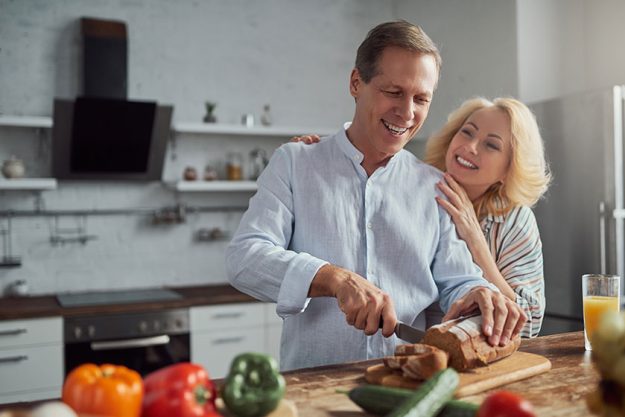 senior couple is cooking in kitchen