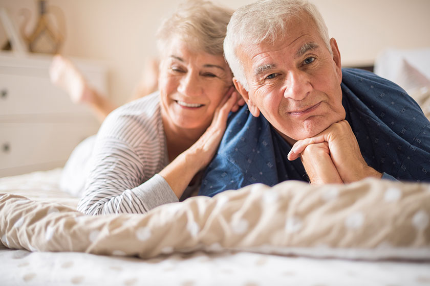 senior couple lying in bed