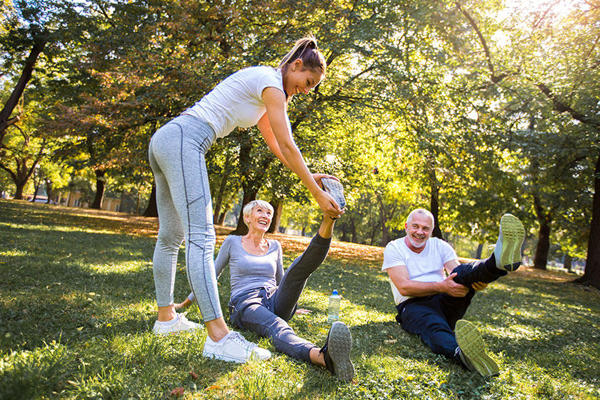 senior man woman young female instructor workout fresh air outdoor