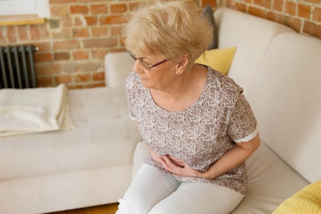 senior woman having stomachache