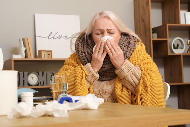 sick mature woman tissue sneezing home
