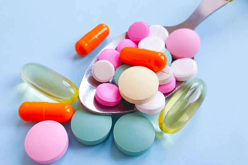 spoon vitamins colored background