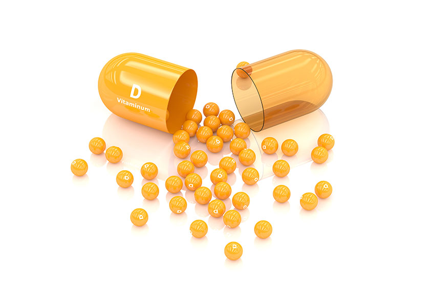 3d rendering vitamin d capsule lying on white 3d rendering vitamin d capsule lying on white