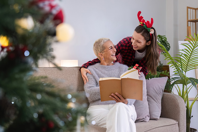 cute young woman holds gift box surprise his mother christmas cute young woman holds gift box surprise his mother christmas