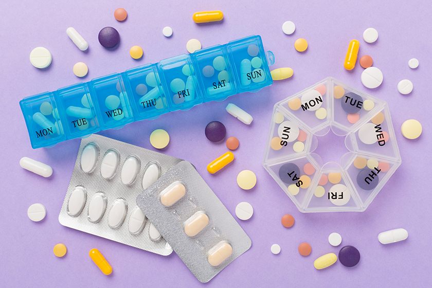 daily pill box medications color background top view 