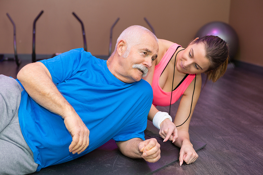 elderly man doing side plank elderly man doing side plank
