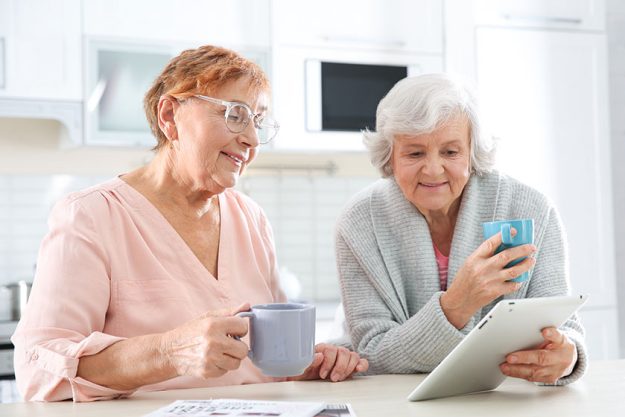 elderly men using tablet table kitchen