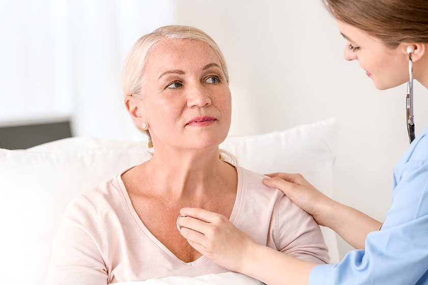 female doctor working patient hospital room