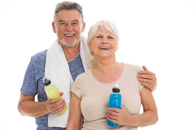 fitness senior couple with towel and bottles