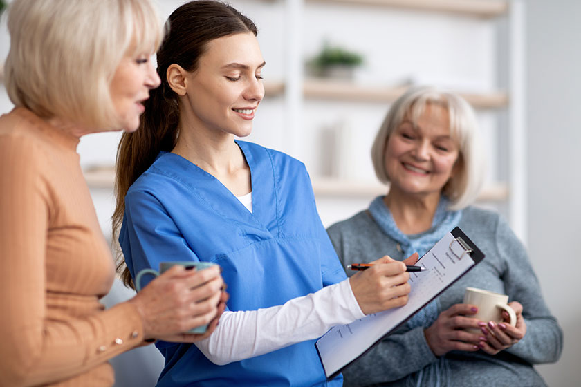 friendly nurse questioning senior ladies at nursing home copy space friendly nurse questioning senior ladies at nursing home copy space