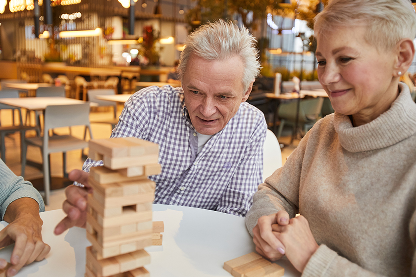 group concentrated senior friends sitting table nursing home leisure room group concentrated senior friends sitting table nursing home leisure room