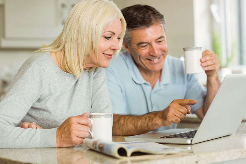 happy mature couple using laptop
