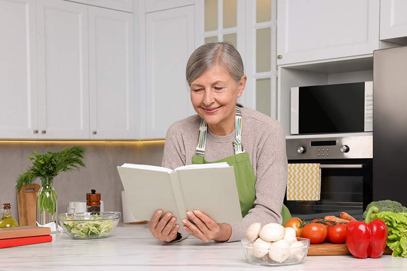 happy woman recipe book table kitchen happy woman recipe book table kitchen