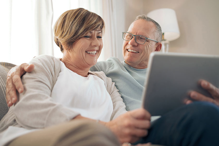 lets watch show you mature relaxing while using digital tablet lets watch show you mature relaxing while using digital tablet