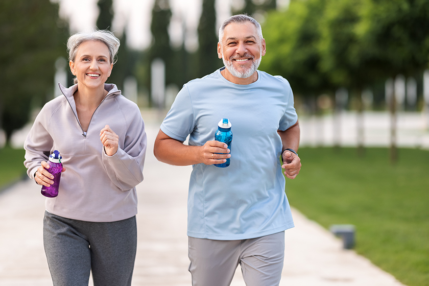 lovely joyful retirees couple jogging city park alley green trees lovely joyful retirees couple jogging city park alley green trees