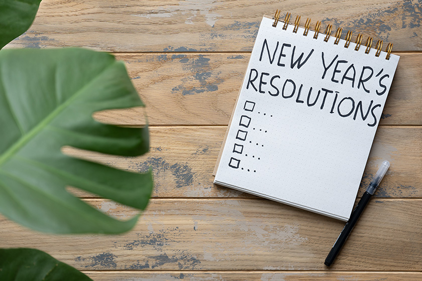 notepad wooden background plans next year inscription new year resolutions